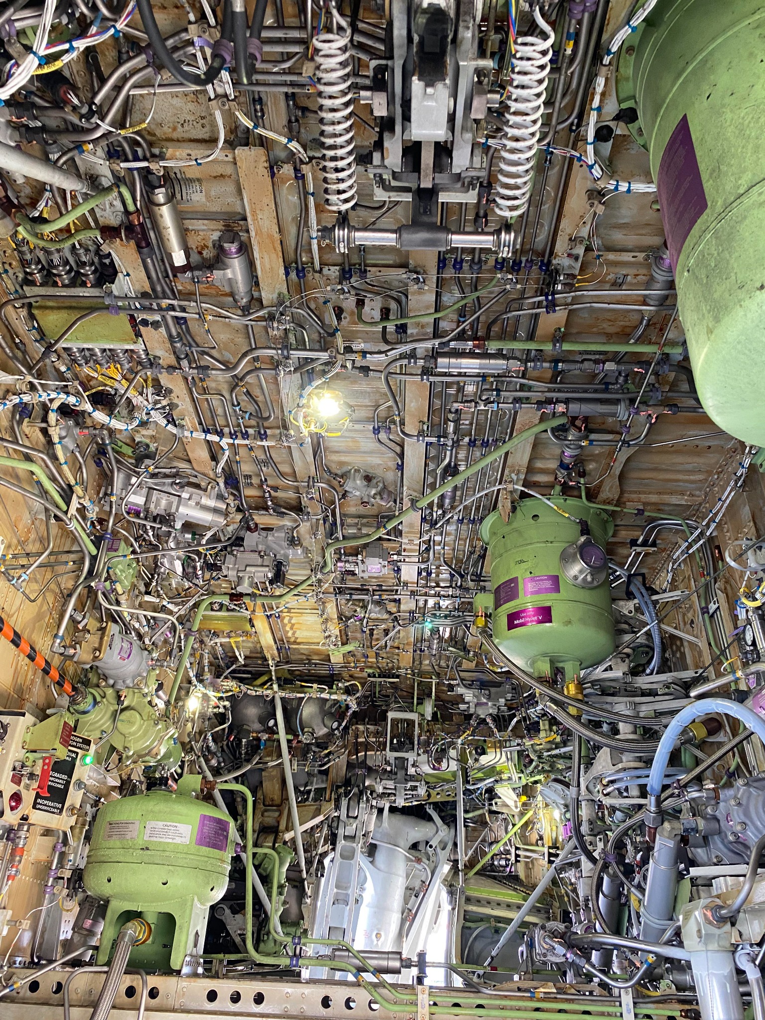 Detailed aircraft systems bay with components, tubing, and wiring